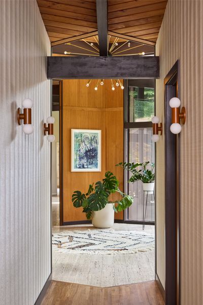 Frank Designs and Petra Design Studio found a vintage Stilnovo Sputnik Chandelier on <a href="https://www.1stdibs.com/">1stDibs</a>, sourced from France. The hallway has the vinyl Keshi wallcovering from <a href="https://shop.designtex.com/keshi/?sku=6555-102">Designtex</a>, with <a href="https://schoolhouse.com/">Schoolhouse</a> sconces.