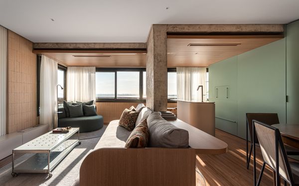 The architects preserved the functions of the porch, as a place to lounge and grill, but removed the walls and doors to integrate them into the home. 