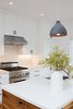 Modern home with Kitchen, Pendant Lighting, Engineered Quartz Counter, Ceiling Lighting, White Cabinet, Range Hood, Range, and Ceramic Tile Backsplashe. Fresh white kitchen with warm wood wrapped island, black cabinet pulls and Dwell patterns Heath tile backsplash . Photo 2 of Chenery Street Remodel