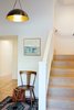 The ground floor entry was once a mix and match of different flooring materials and floor level heights. All the details were though out to create a functional, one-level space with new white oak flooring and stair treads to match the upstairs rooms. Photo 11 of Chenery Street Remodel modern home