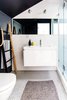 Modern home with Bath Room, Enclosed Shower, Wall Lighting, Accent Lighting, Ceramic Tile Wall, Undermount Sink, Ceramic Tile Floor, Wall Mount Sink, Engineered Quartz Counter, and One Piece Toilet. The full bathroom includes Ann Sacks tiles, a wall-hung toilet and a black and white color scheme. Photo 12 of 21st Street Cottage Remodel