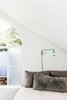 Modern home with Bedroom, Bed, Wall Lighting, Accent Lighting, and Light Hardwood Floor. Most of the windows and doors needed to be replaced with new, but luckily we were able to salvage and re-use this beautiful arch-top window. Photo 9 of 21st Street Cottage Remodel