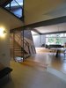 entry hall looking S: dining room w/living room beyond. steel, single stringer cantilever stair. perforated aluminum screen. 12 x 24 porcelain ceramic tile, 2 ¼” oak strip flooring from renewable forests. Photo 6 of metalHOUSE(2) modern home