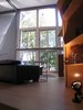 looking S into the living space: an 8” steel beam braces the 20’ x 23’ window wall. tracklighting is integrated into the web for uplighting. afternoon light from the “tweezer” windows. Photo 8 of metalHOUSE(2) modern home