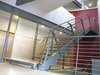looking NE from the dining room into the solar chimney: steel tube single stringer. ¼” folded steel cantilevered brackets form the treads/risers. ¾” oak applied wearing surface. ¼” steel verticals, ½” rod balusters w/1 ½” steel top tube rail. steel angle frame w/perforated aluminum infill screen, entry hall beyond. transom at upper tight is in the hall bath shower. Photo 13 of metalHOUSE(2) modern home