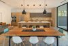 Modern home with Kitchen, Engineered Quartz Counter, Wood Cabinet, Porcelain Tile Backsplashe, Refrigerator, Accent Lighting, Cooktops, and Wall Oven. Dining/Kitchen Photo 17 of Pavilion Haus