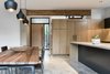 Modern home with Kitchen, Wood Cabinet, Pendant Lighting, and Concrete Floor. View of Foyer from Dining Room & Kitchen Photo 2 of Wharton Residence