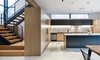 Modern home with Kitchen, Concrete Floor, Ceiling Lighting, and Wood Cabinet. View of Kitchen and Stairs Photo 3 of Wharton Residence