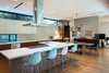 Modern home with Kitchen, Wood Cabinet, White Cabinet, Light Hardwood Floor, and Engineered Quartz Counter. Interior View Photo 4 of McClendon Residence