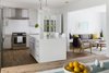 By expanding the existing opening between the family room and kitchen/dining, we were able to create a light filled open floor plan for the public space. Photo of St. Johns House modern home