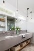 The new Master Bathroom features a 9 foot floating vanity with wall mount faucets and new clerestory windows above. Photo 11 of St. Johns House modern home