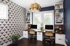 Across from the craft area we built a custom 30" deep desk with stained pecan top, central trash bin pull out, file storage on either side, and concealed wire storage cabinet with an easy access panel. An accent wall of Serena & Lily wallpaper and chandelier by Aerin really bring an elegant touch to this home office. Photo 2 of Mueller Home Office modern home