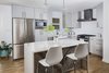The kitchen features an all new layout which now includes an island with waterfall drop edge countertop and reclaimed wood from Delta Millworks. Photo 2 of St. Johns Mid-Century Remodel modern home