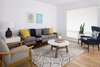 The living room features beautiful window coverings by Austintatious Blinds and furniture by West Elm. Photo 9 of St. Johns Mid-Century Remodel modern home