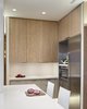 Modern home with Engineered Quartz Counter, Vinyl Floor, Wood Cabinet, White Cabinet, Laminate Cabinet, Metal Cabinet, Ceiling Lighting, Dishwasher, Undermount Sink, Refrigerator, Wine Cooler, and Kitchen. Kitchen: Corner View Photo 4 of State-of-the-Art Central Park Kitchen, NY