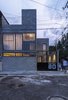 Modern home with Exterior, House Building Type, Tile Roof Material, Brick Siding Material, Flat RoofLine, and Concrete Siding Material. located in a quiet area, this house pretends to create a link and dialogue with its neighborhood. Photo of Melón House