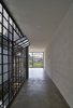 Modern home with Hallway and Concrete Floor. the natural illumination and ventilation is allowed through large windows Photo 8 of Melón House