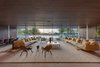 Modern home with Concrete Floor, Living Room, Sofa, Coffee Tables, and Chair. The living room features lots of seating for entertaining and unobstructed views of the water. Photo 6 of Pine Tree North