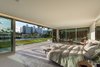 Modern home with Trees, Sofa, Gardens, Shrubs, Concrete Patio, Porch, Deck, Chair, Limestone Floor, Stone Counter, Wood Cabinet, Range Hood, Range, Drop In Sink, Table, Pendant Lighting, and Bedroom. Floor-to-ceiling sliding glass doors open up to the water in the master bedroom. Photo 9 of Pine Tree North