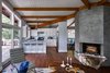 Modern home with Marble Backsplashe, Picture Window Type, White Cabinet, Range, Range Hood, Refrigerator, and Kitchen. New kitchen expands in all directions - from living room to ipe deck. Photo of Highland Perch House