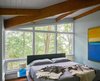 Modern home with Picture Window Type, Casement Window Type, Bedroom, Storage, Medium Hardwood Floor, Bed, and Night Stands. New floor-to-ceiling windows bring dawn light and bird calls into the Master Bedroom. Photo 5 of Highland Perch House