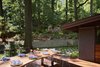 Modern home with Trees, Wood Patio, Porch, Deck, Hardscapes, Decking Patio, Porch, Deck, Metal Patio, Porch, Deck, Rooftop, Large Patio, Porch, Deck, Shrubs, Back Yard, Gardens, Grass, Walkways, Outdoor, and Front Yard. The new ipe deck and backyard landscaping merge seamlessly as one expansive outdoor space. Photo 8 of Highland Perch House