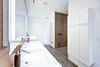 Modern home with Hardscapes, Walkways, Large Patio, Porch, Deck, Planters Patio, Porch, Deck, Decking Patio, Porch, Deck, Horizontal Fences, Wall, Grass, Shrubs, Trees, Boulders, Sectional, Concrete Floor, Bed, Front Yard, Night Stands, Wall Lighting, Ceiling Lighting, and Bath Room. master bath Photo 10 of Atlantic Beach Modern