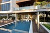 Modern home with Walkways, Back Yard, Hardscapes, Small Pools, Tubs, Shower, Large Patio, Porch, Deck, Planters Patio, Porch, Deck, Decking Patio, Porch, Deck, Horizontal Fences, Wall, Concrete Pools, Tubs, Shower, Exterior, Wood Siding Material, House Building Type, and Stucco Siding Material. Covered deck, sunken fire pit, and pool Photo 5 of Atlantic Beach Modern