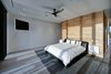 Modern home with Hardscapes, Horizontal Fences, Wall, Planters Patio, Porch, Deck, Walkways, Large Patio, Porch, Deck, Decking Patio, Porch, Deck, Grass, Shrubs, Trees, Front Yard, Boulders, Sectional, Ceiling Lighting, Concrete Floor, and Bedroom. master bedroom Photo 9 of Atlantic Beach Modern