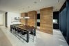 Modern home with Hardscapes, Horizontal Fences, Wall, Decking Patio, Porch, Deck, Walkways, Large Patio, Porch, Deck, Planters Patio, Porch, Deck, Grass, Shrubs, Trees, Front Yard, Boulders, Sectional, Bed, Night Stands, Ceiling Lighting, Engineered Quartz Counter, Ceramic Tile Floor, Concrete Floor, Undermount Sink, and Open Shower. dining and kitchen Photo 20 of Atlantic Beach Modern