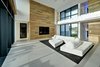 Modern home with Hardscapes, Horizontal Fences, Wall, Walkways, Decking Patio, Porch, Deck, Large Patio, Porch, Deck, Planters Patio, Porch, Deck, Grass, Shrubs, Trees, Front Yard, Boulders, Sectional, Bed, Night Stands, Wall Lighting, Ceiling Lighting, Engineered Quartz Counter, Ceramic Tile Floor, Concrete Floor, and Undermount Sink. living room Photo 18 of Atlantic Beach Modern