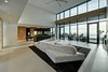 Modern home with Walkways, Planters Patio, Porch, Deck, Hardscapes, Large Patio, Porch, Deck, Decking Patio, Porch, Deck, Horizontal Fences, Wall, Grass, Shrubs, Trees, Front Yard, Boulders, Sectional, Bed, Night Stands, Wall Lighting, Ceiling Lighting, Ceramic Tile Floor, Engineered Quartz Counter, Concrete Floor, and Undermount Sink. view to kitchen and dining area from living Photo 17 of Atlantic Beach Modern