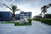 Modern home with Walkways, Decking Patio, Porch, Deck, Hardscapes, Large Patio, Porch, Deck, Planters Patio, Porch, Deck, Horizontal Fences, Wall, Grass, Shrubs, Trees, Front Yard, Side Yard, and Outdoor. street facing facade Photo 7 of Atlantic Beach Modern