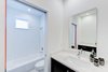 Modern home with Dresser, Carpet Floor, Bed, Chair, Table Lighting, and Bath Room. bathroom Photo 3 of Cedarbrook Net Zero Modern