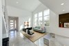 Modern home with Bed, Engineered Quartz Counter, Carpet Floor, Dresser, Chair, Undermount Sink, Alcove Tub, Ceiling Lighting, Ceramic Tile Wall, Two Piece Toilet, Trees, Shrubs, Grass, Walkways, Back Yard, Large Patio, Porch, Deck, Sofa, Concrete Floor, Table, and Stools. living Photo 10 of Cedarbrook Net Zero Modern