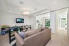 Modern home with Hardscapes, White Cabinet, Small Patio, Porch, Deck, Horizontal Fences, Wall, Wood Cabinet, Wood Tread, Ceramic Tile Backsplashe, Recessed Lighting, Accent Lighting, Refrigerator, Range, Range Hood, Dishwasher, Wood Railing, Front Yard, Concrete Patio, Porch, Deck, Metal Fences, Wall, Sectional, Ottomans, and Bookcase. Sliding Door Co. doors in basement, hiding office and guest BR Photo 16 of 30th Street Residence