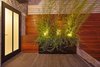 Modern home with Outdoor, Wood Fences, Wall, Landscape Lighting, Tile Patio, Porch, Deck, Horizontal Fences, Wall, and Wood Patio, Porch, Deck. A new ipe wall covers a portion of the neighboring building. Photo 8 of Dolores Street