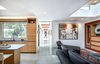 Modern home with Living Room, Coffee Tables, Sofa, Ceiling Lighting, and Concrete Floor. The living room and kitchen. Photo of Oak Street