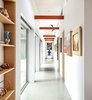 Modern home with Hallway and Concrete Floor. The gallery-like hallway leads to the back of the house. Photo 2 of Oak Street
