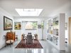 Modern home with Dining Room, Chair, Table, Pendant Lighting, Accent Lighting, Recessed Lighting, and Concrete Floor. The dining room sits within an open plan, but is defined by a clerestory pop-up and a display wall. Photo 3 of Oak Street