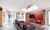 Modern home with Living Room, Sectional, Accent Lighting, Recessed Lighting, Gas Burning Fireplace, Coffee Tables, Concrete Floor, and Two-Sided Fireplace. The fireplace wall is an acid washed and stained steel wrap. Photo 6 of Oak Street