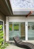 Modern home with Exterior. A rain chain directs rainwater to a collection pit. A deep overhang, partly solid and partially open protects the window wall and dapples light across it. Photo 14 of Oak Street
