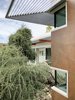 Modern home with Exterior. Steel sunshades and corten-inspired wall tile. Photo 15 of Oak Street