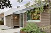 Modern home with Exterior. A simple palette of white stucco and cedar with sunshade accents. Photo 16 of Oak Street