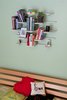 Modern home with Shelves, Front Yard, Flowers, Grass, Wood Patio, Porch, Deck, Storage, Coffee Tables, Wood Burning Fireplace, Bookcase, and Living Room. fleimio pine cone wall shelf in the guest room. Photo 5 of Home Tuusula