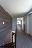 Modern home with Ceiling Lighting, Engineered Quartz Counter, Undermount Sink, Freestanding Tub, Enclosed Shower, White Cabinet, Wood Cabinet, Back Yard, Plunge Pools, Tubs, Shower, Concrete Pools, Tubs, Shower, Large Patio, Porch, Deck, Decking Patio, Porch, Deck, Horizontal Fences, Wall, Metal Fences, Wall, Sofa, Coffee Tables, Wood Tread, Wood Railing, Metal Railing, and Bunks. Owner's suite hall leading to library and private office Photo 14 of NJPV