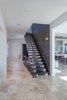 Modern home with Bed, Enclosed Shower, Undermount Sink, Engineered Quartz Counter, Freestanding Tub, Ceiling Lighting, White Cabinet, Wood Cabinet, Travertine Floor, Back Yard, Plunge Pools, Tubs, Shower, Concrete Pools, Tubs, Shower, Large Patio, Porch, Deck, Decking Patio, Porch, Deck, Horizontal Fences, Wall, Metal Fences, Wall, Chair, Sofa, Coffee Tables, and Wood Tread. Main hall with floating stair Photo 12 of NJPV
