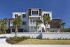 Modern home with Bed, Freestanding Tub, Ceiling Lighting, Engineered Quartz Counter, Undermount Sink, Dark Hardwood Floor, Enclosed Shower, Front Yard, Trees, Shrubs, Grass, Walkways, Landscape Lighting, and Outdoor. Street view of the house from Historic A1A Photo 5 of NJPV