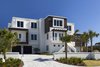 Modern home with Bed, Ceiling Lighting, Freestanding Tub, Dark Hardwood Floor, Engineered Quartz Counter, Undermount Sink, Front Yard, Trees, Shrubs, Grass, Enclosed Shower, Walkways, Landscape Lighting, and Outdoor. Street view of the house from Historic A1A Photo 6 of NJPV