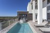 Modern home with Bed, Ceiling Lighting, Engineered Quartz Counter, Undermount Sink, Freestanding Tub, Enclosed Shower, Shrubs, White Cabinet, Wood Cabinet, Travertine Floor, Back Yard, and Outdoor. Pool view with cabana in the background Photo 9 of NJPV
